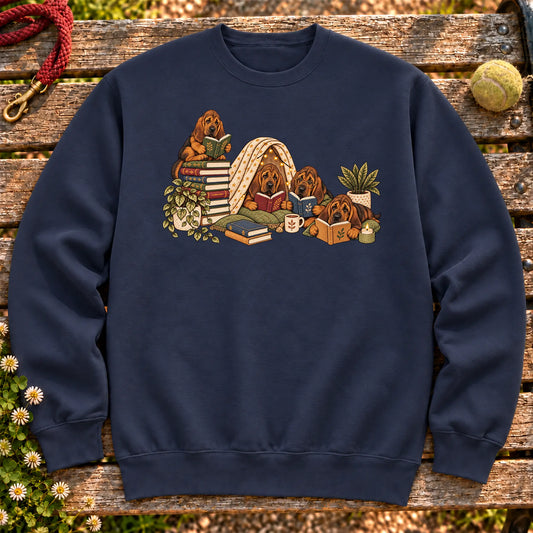 Bloodhound puppies reading books in a cozy blanket fort on a Navy sweatshirt