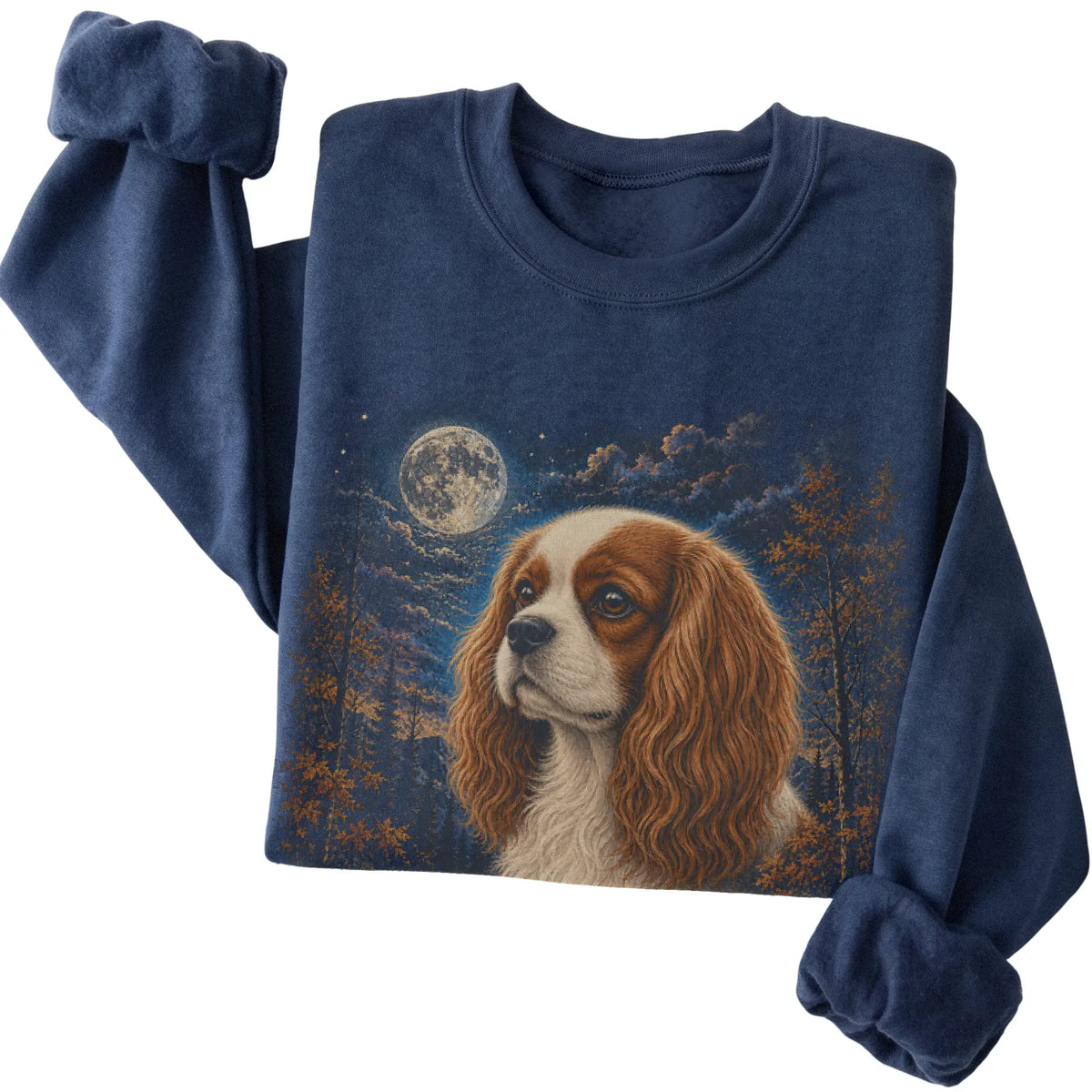 Folded navy sweatshirt with Cavalier King Charles Spaniel Autumn Moon artwork.