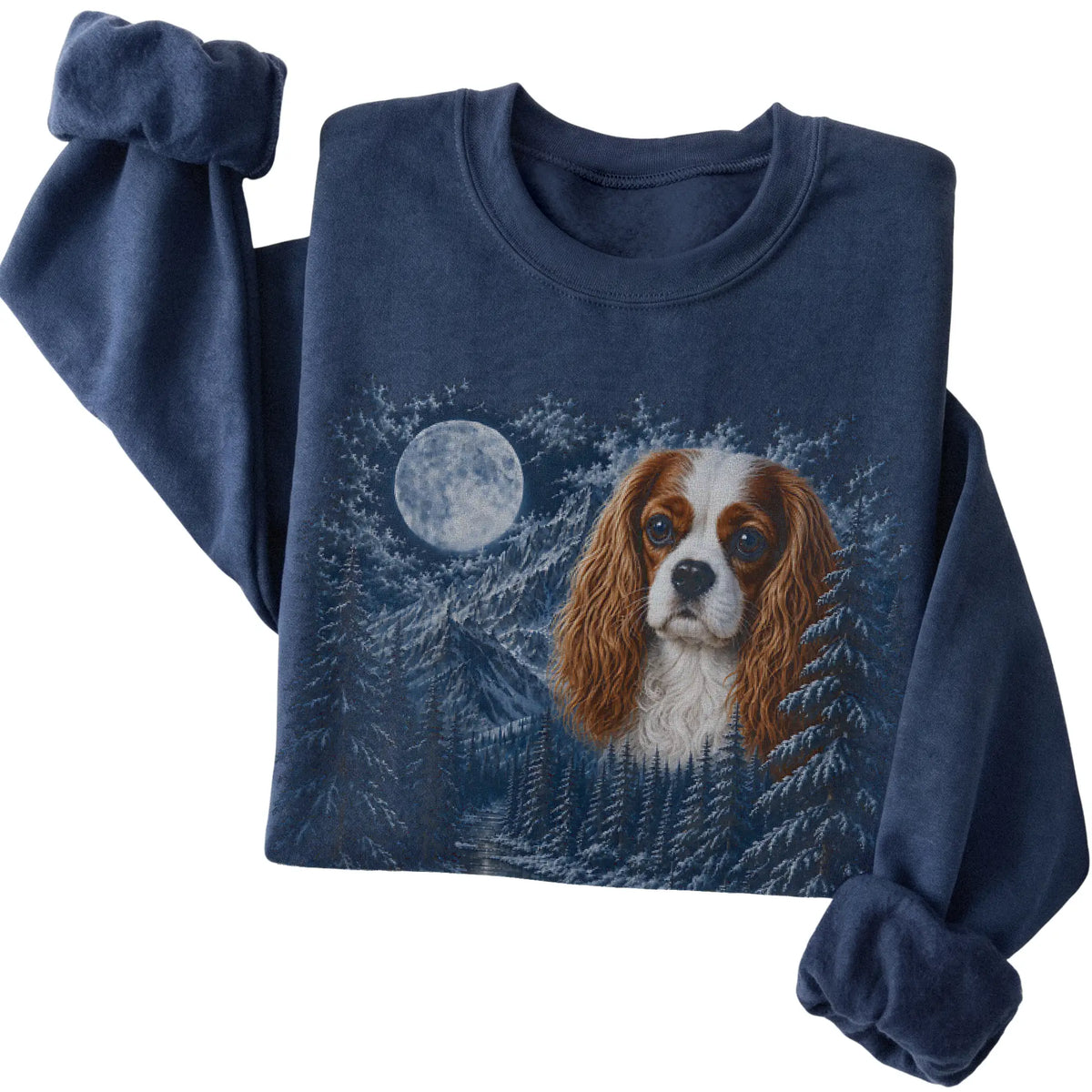 Folded navy sweatshirt with Cavalier King Charles Spaniel Winter Moon artwork.