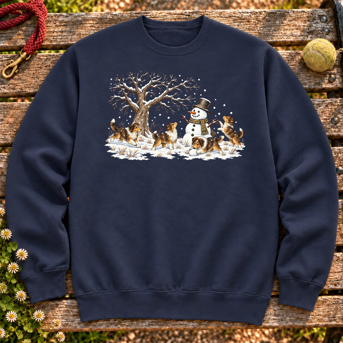 Collie puppies playing in snow with a snowman on a Navy sweatshirt