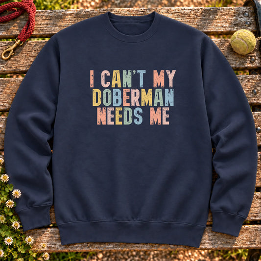 I Can't My Doberman Needs Me text design on a Navy crewneck sweatshirt