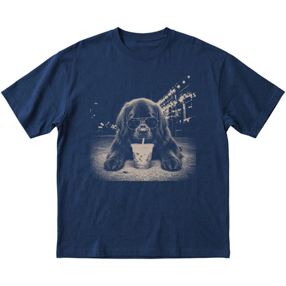 Newfie wearing aviator sunglasses and drinking iced coffee on a Navy Gildan Softstyle T-Shirt, flat lay view