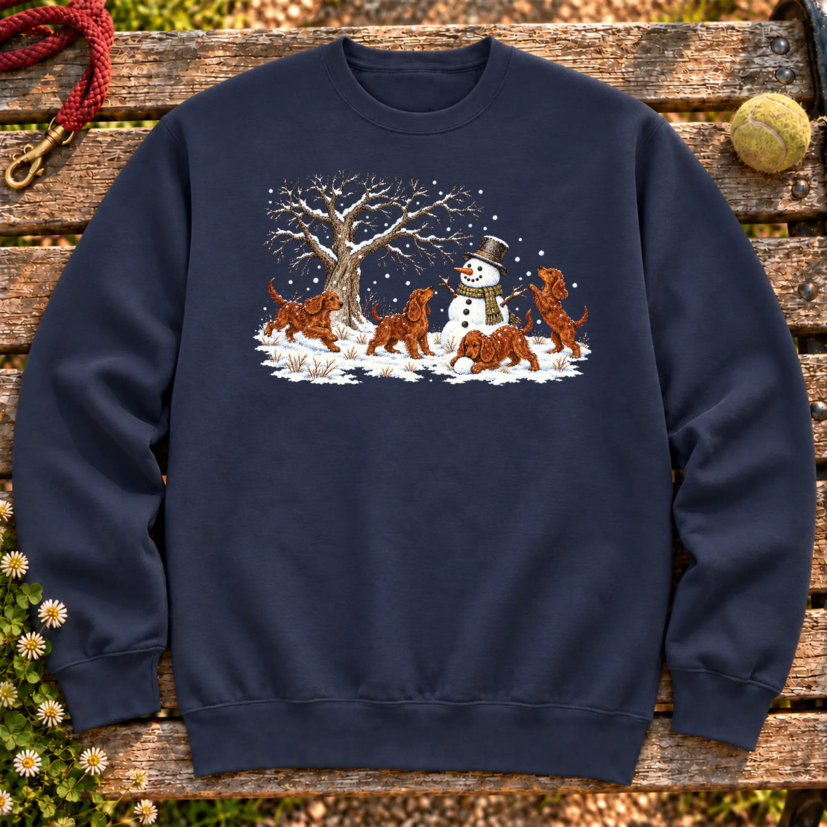 Irish Setter puppies playing in snow with a snowman on a Navy sweatshirt