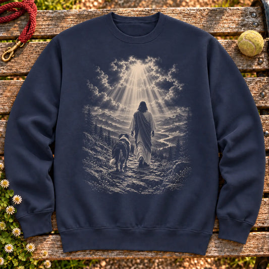 Navy crewneck sweatshirt showing Jesus walking beside a Bernese Mountain Dog beneath rays of light