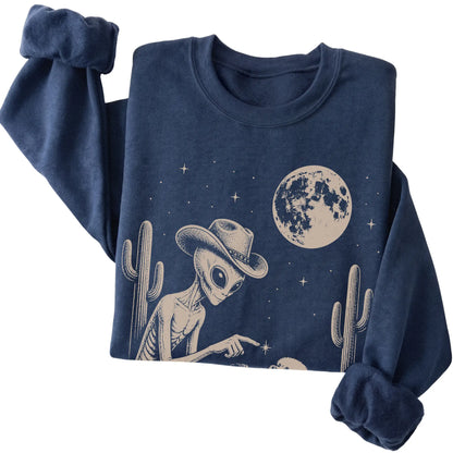 Navy crewneck sweatshirt featuring Maltese Cowboy and Alien, folded presentation