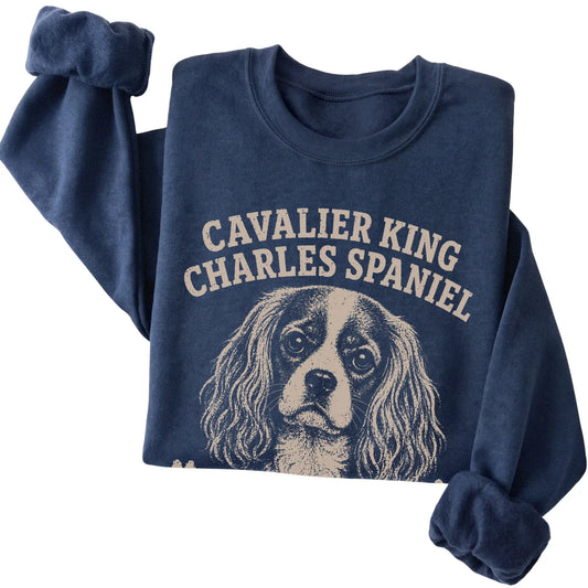 Navy crewneck sweatshirt featuring Professionally Affectionate - Cavalier King Charles Spaniel, folded presentation