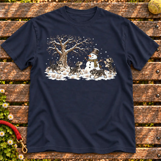 Schnauzer puppies playing in snow with a snowman on a Navy T-shirt