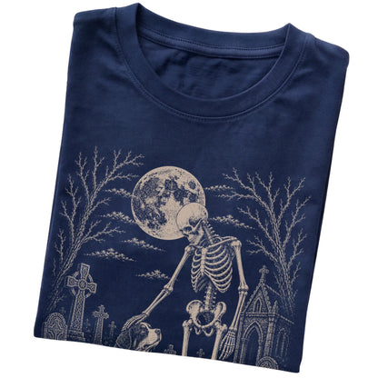 Folded Navy T-shirt with a skeleton petting a Bernese Mountain Dog in a graveyard