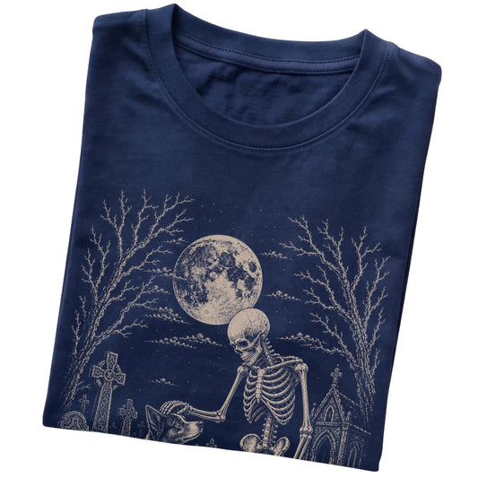 Folded Navy T-shirt with a skeleton petting a Border Collie in a graveyard