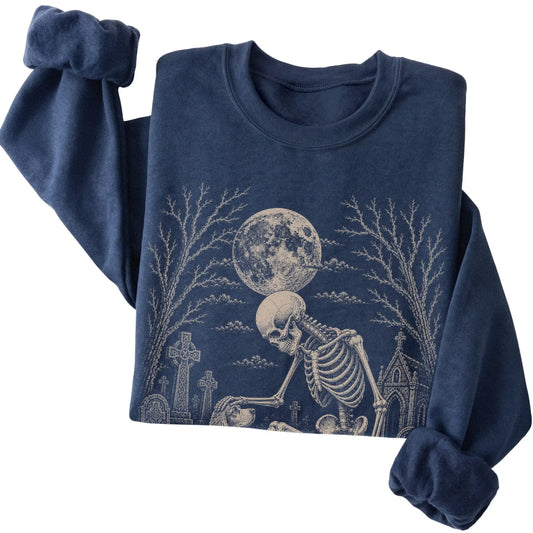 Folded Navy sweatshirt with a skeleton petting a Cocker Spaniel in a graveyard