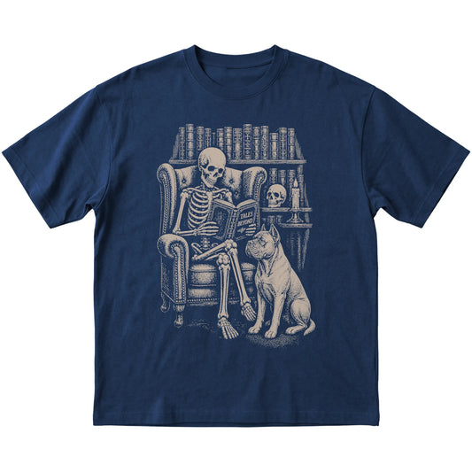 Skeleton reading Tales Beyond to a Cane Corso on a Navy T-shirt