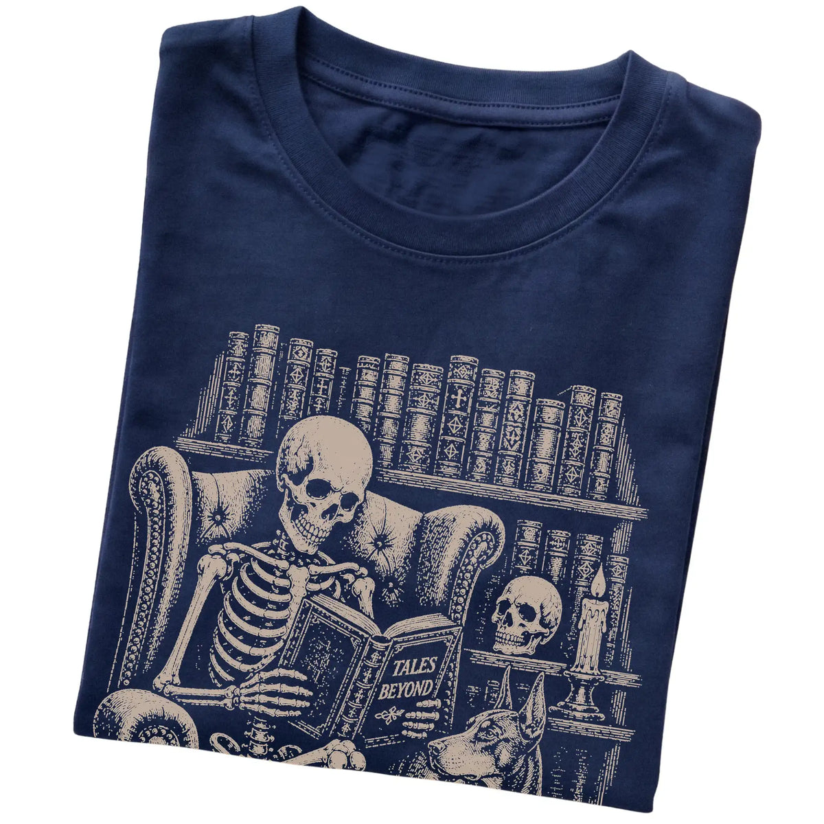 Folded Navy T-shirt with a skeleton reading Tales Beyond to a Doberman