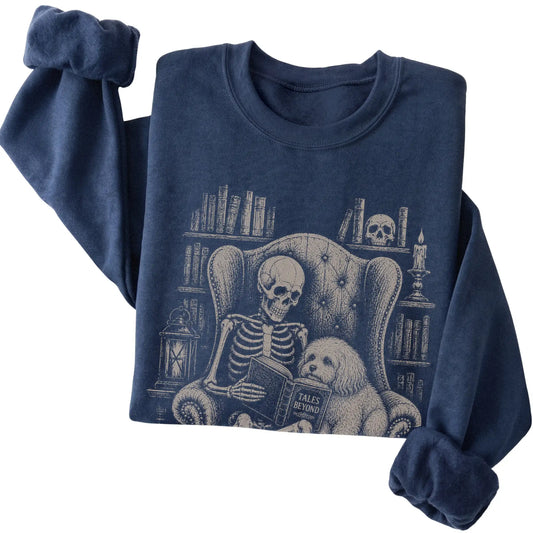 Folded Navy sweatshirt with a skeleton reading Tales Beyond to a Havanese