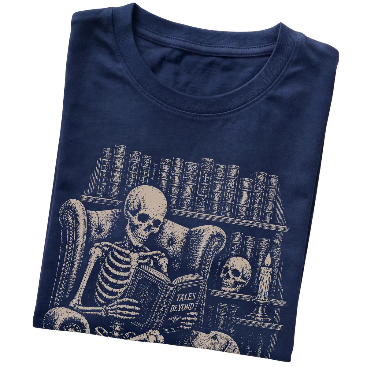 Folded Navy T-shirt with a skeleton reading Tales Beyond to a Weimaraner