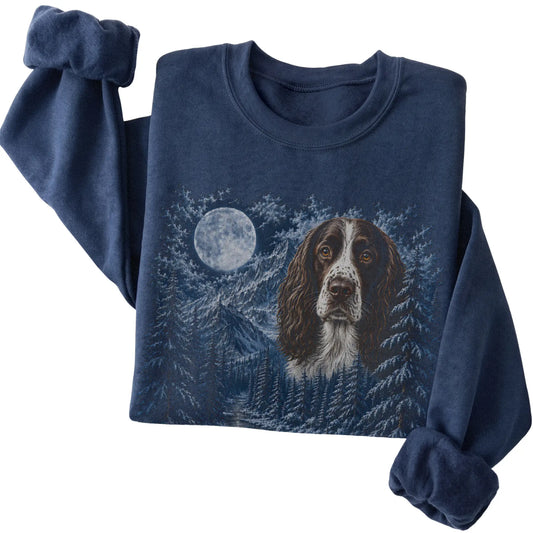 Folded navy sweatshirt with Springer Spaniel Winter Moon artwork.