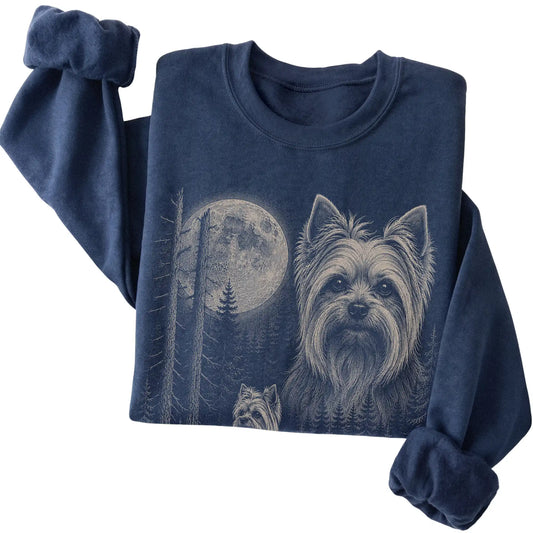 Folded navy crewneck sweatshirt showing the Yorkie Moonlit Forest graphic