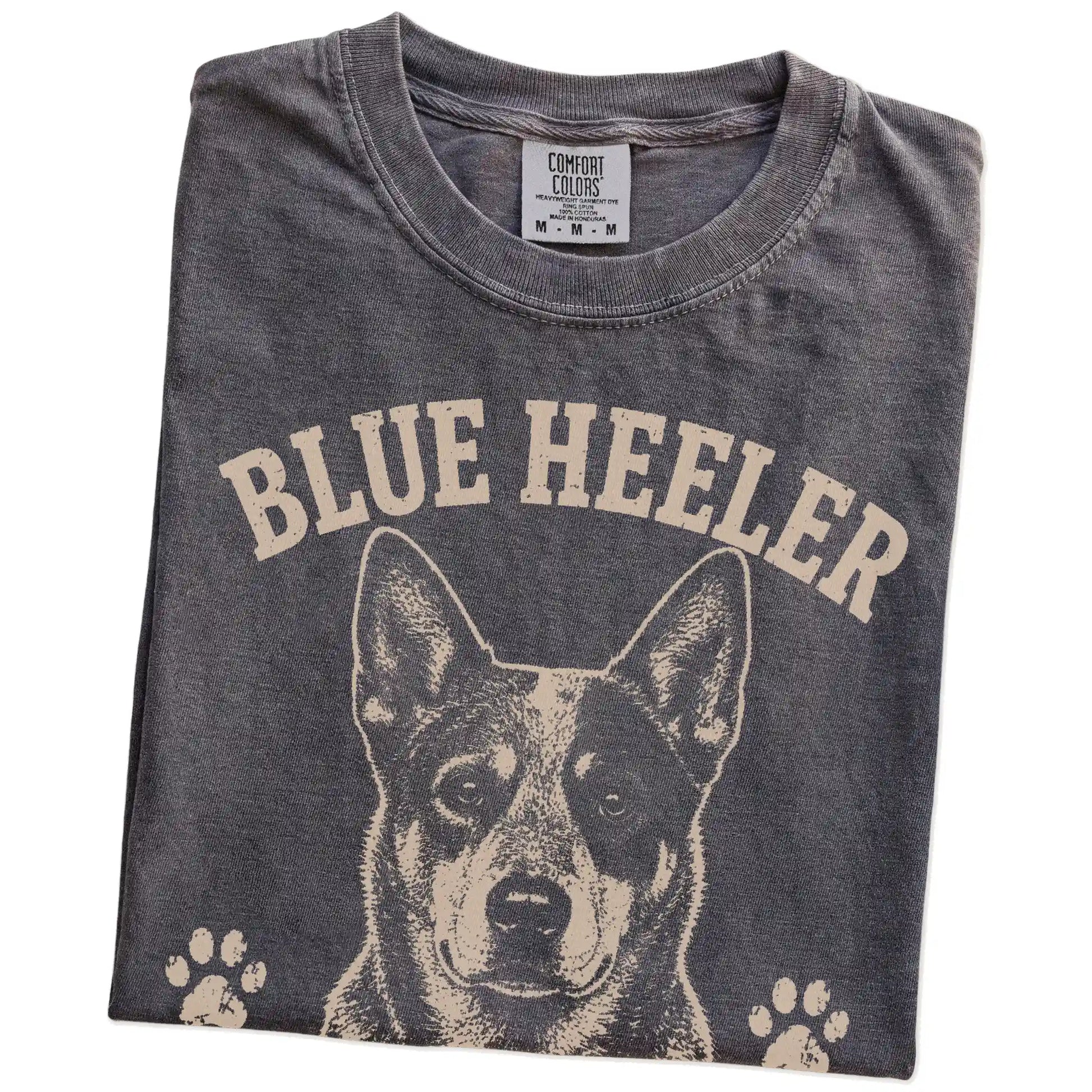 Folded Pepper Comfort Colors® T-shirt showing Blue Heeler design with “Always Working, Even When I'm Not” lettering
