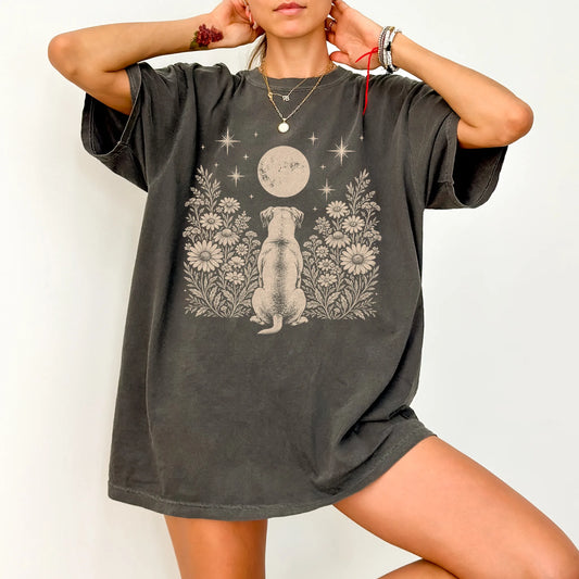 Model wearing a Pepper Comfort Colors® T-shirt featuring American Bulldog beneath a wildflower moon