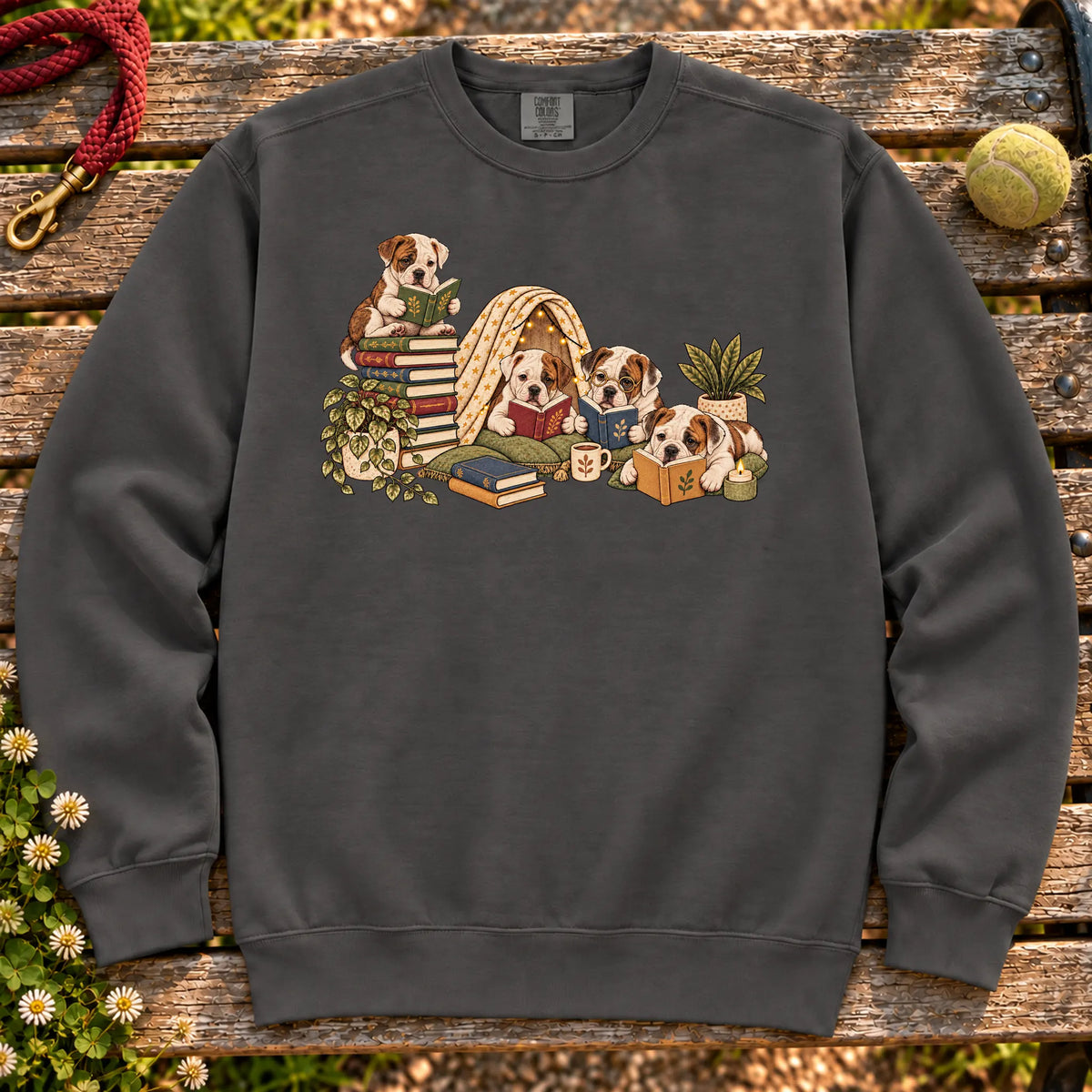 American Bulldog puppies reading books in a cozy blanket fort on a Pepper sweatshirt