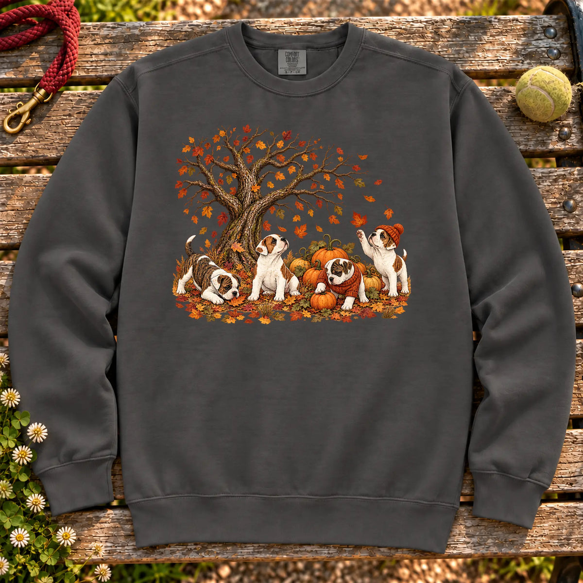 Four American Bulldog puppies with pumpkins beneath an autumn tree on a Pepper garment-dyed sweatshirt