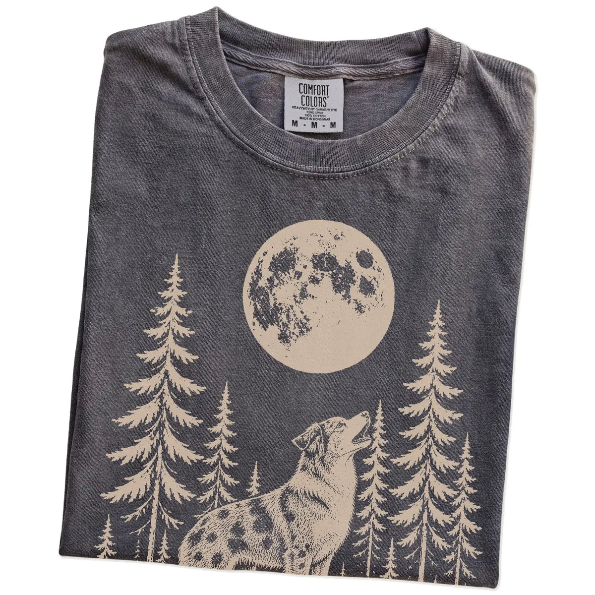 Folded Pepper Comfort Colors® T-shirt showing a Australian Shepherd howling beneath the moon and pine trees