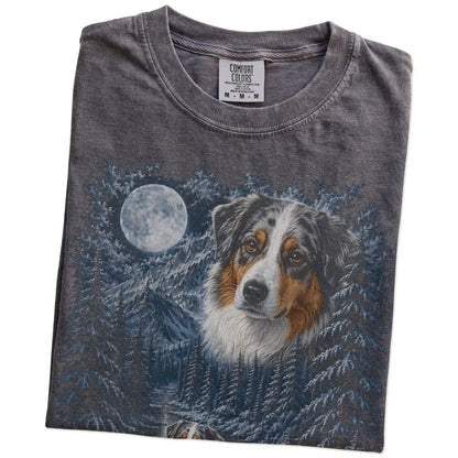Folded pepper T-shirt with Australian Shepherd Winter Moon artwork.