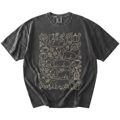 Basset Hound dogs with pumpkins, leaves, acorns, and woodland details on a Pepper Comfort Colors® T-shirt