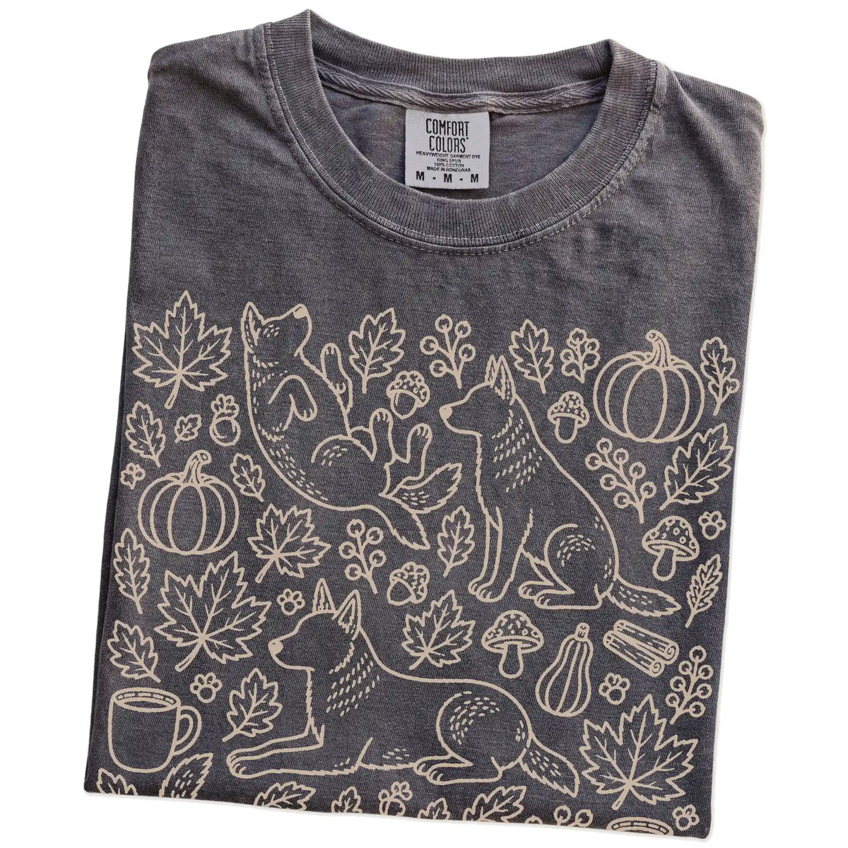 Folded Pepper Comfort Colors® T-shirt showing Blue Heeler dogs with pumpkins, leaves, acorns, and woodland details