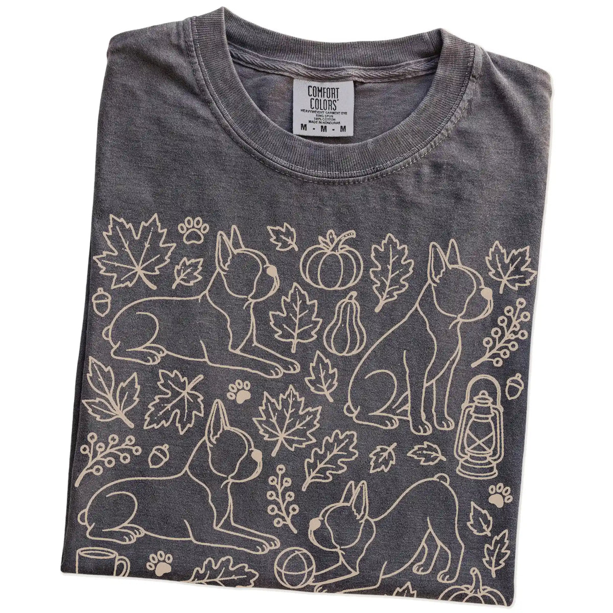 Folded Pepper Comfort Colors® T-shirt showing Boston Terrier dogs with pumpkins, leaves, acorns, and woodland details