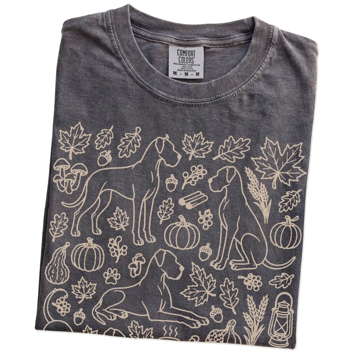 Folded Pepper Comfort Colors® T-shirt showing Great Dane dogs with pumpkins, leaves, acorns, and woodland details