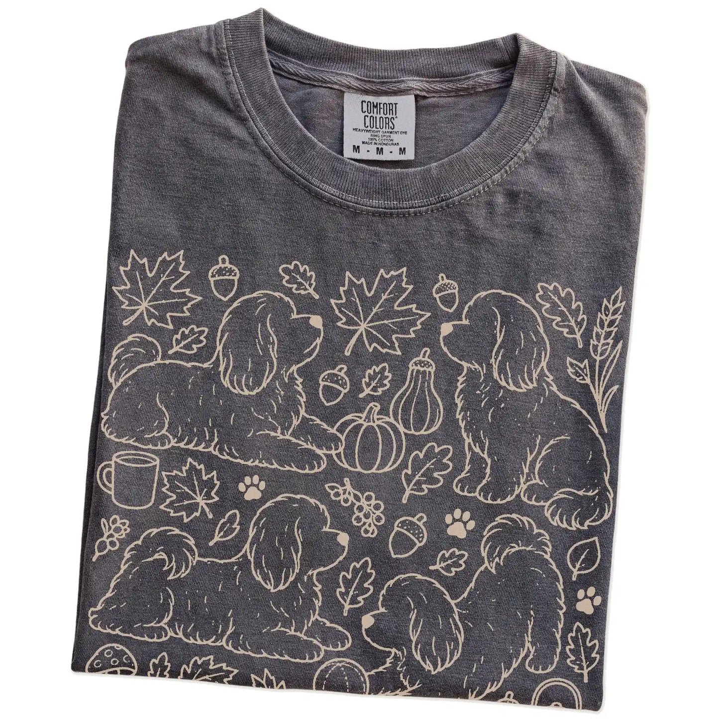 Folded Pepper Comfort Colors® T-shirt showing Havanese dogs with pumpkins, leaves, acorns, and woodland details