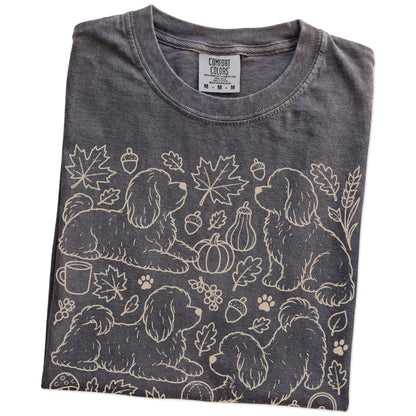 Folded Pepper Comfort Colors® T-shirt showing Havanese dogs with pumpkins, leaves, acorns, and woodland details
