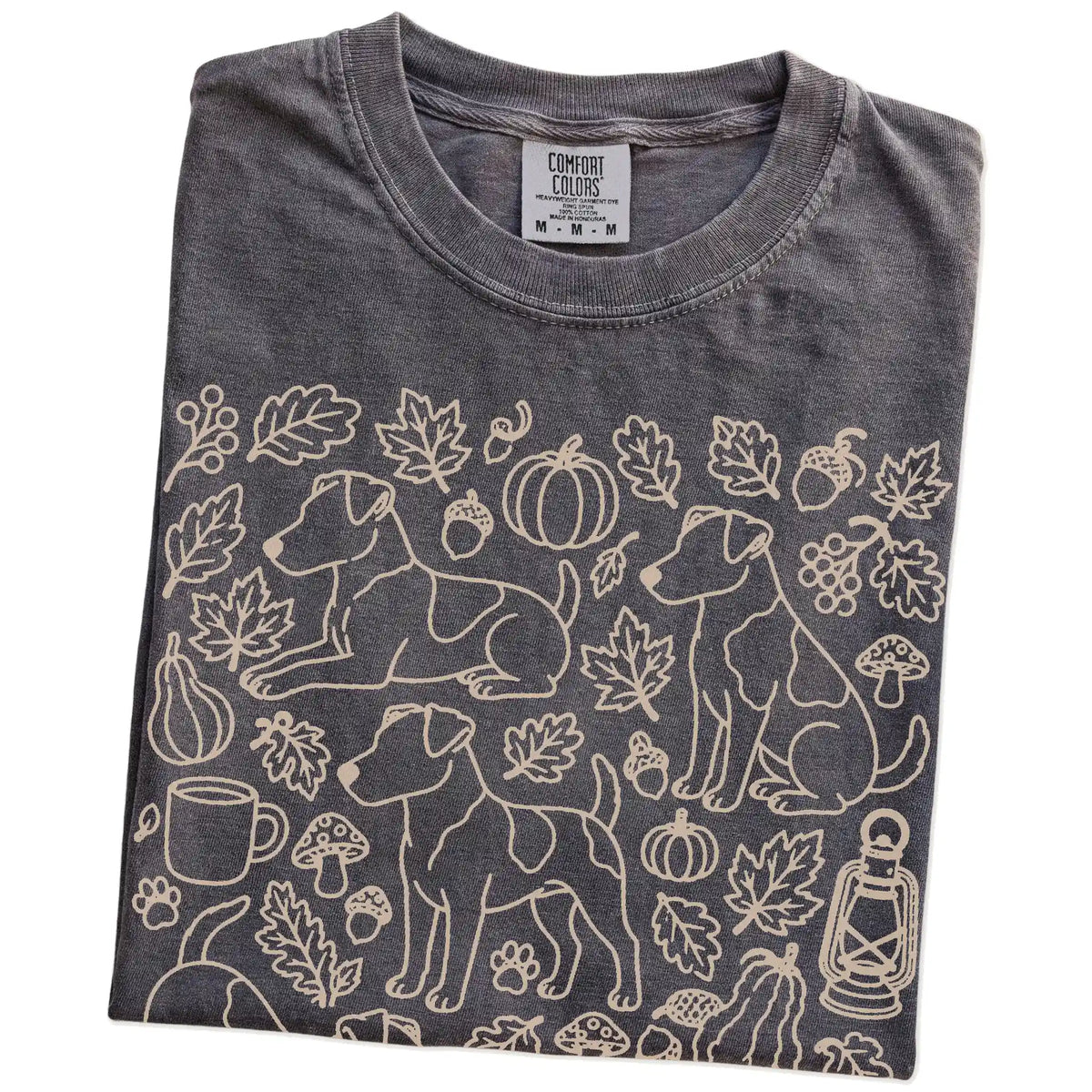 Folded Pepper Comfort Colors® T-shirt showing Jack Russell dogs with pumpkins, leaves, acorns, and woodland details
