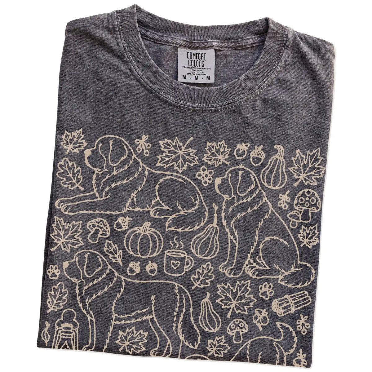 Folded Pepper Comfort Colors® T-shirt showing Saint Bernard dogs with pumpkins, leaves, acorns, and woodland details