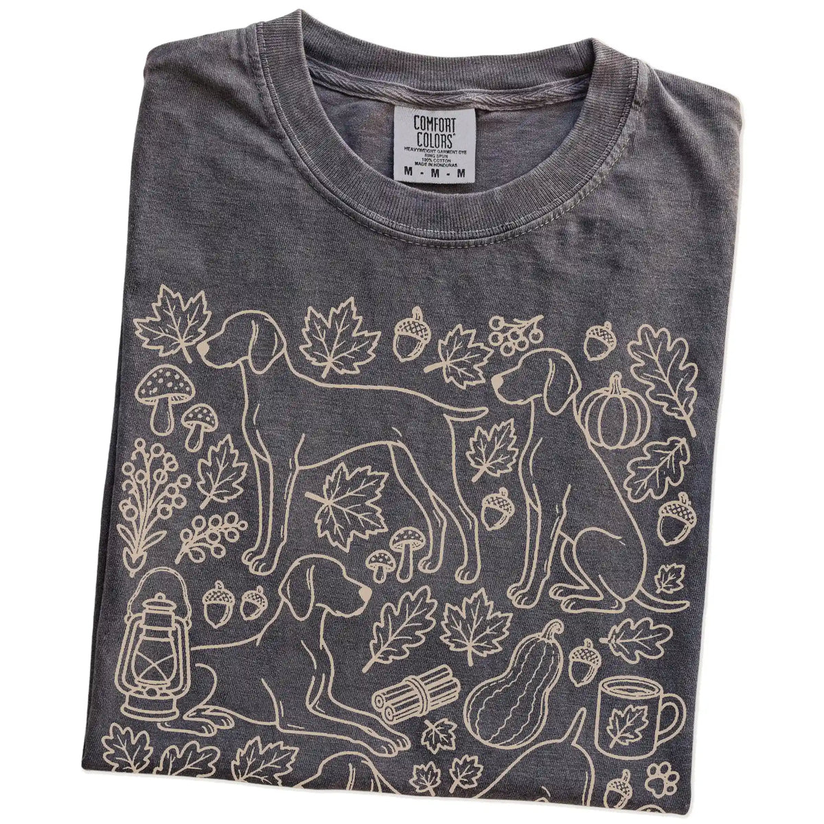 Folded Pepper Comfort Colors® T-shirt showing Weimaraner dogs with pumpkins, leaves, acorns, and woodland details