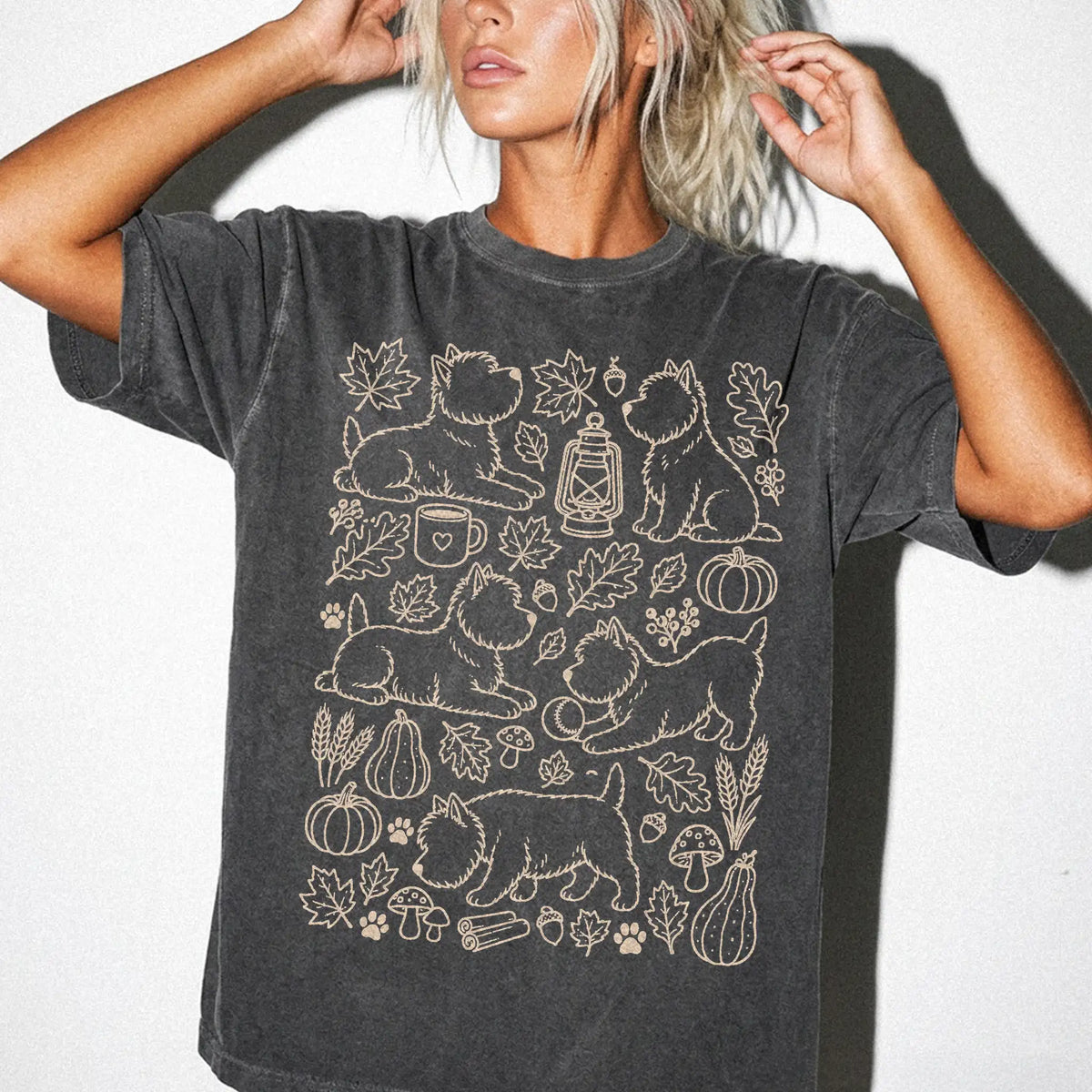 Model wearing a Pepper Comfort Colors® T-shirt with Westie dogs with pumpkins, leaves, acorns, and woodland details