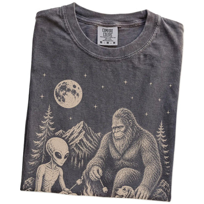 Folded Pepper Comfort Colors® T-shirt showing Beagle camping with Bigfoot and an alien
