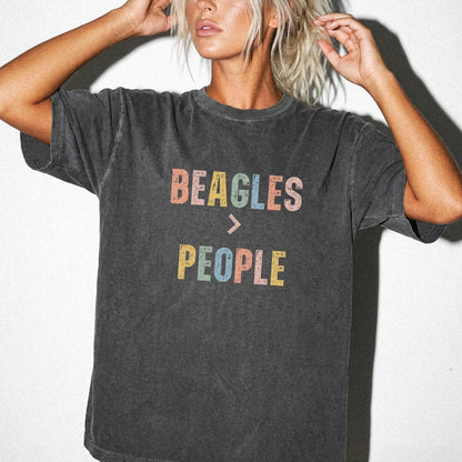 Model wearing a Pepper Comfort Colors® T-shirt with “Beagles > People” text