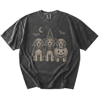 Three Beagle dogs dressed for Halloween beneath bats and a crescent moon on a Pepper Comfort Colors® T-shirt