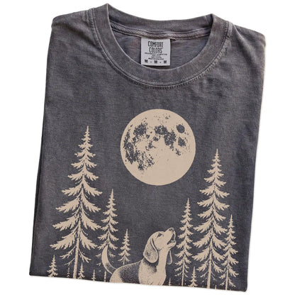 Folded Pepper Comfort Colors® T-shirt showing a Beagle howling beneath the moon and pine trees