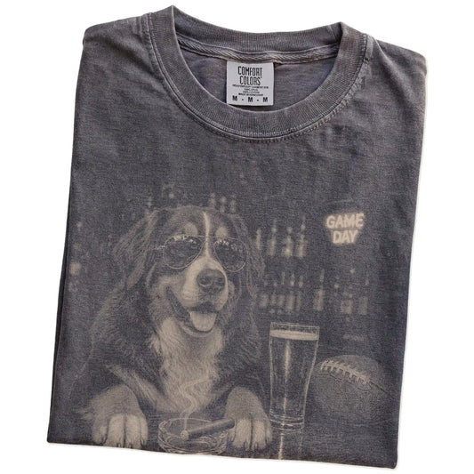 Folded Pepper Comfort Colors® T-shirt showing Bernese Mountain Dog with beer and football graphics