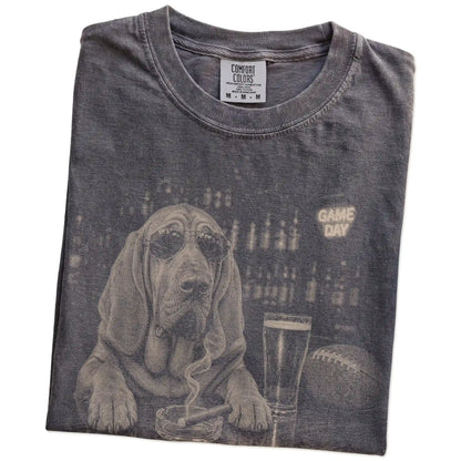 Folded Pepper Comfort Colors® T-shirt showing Bloodhound with beer and football graphics