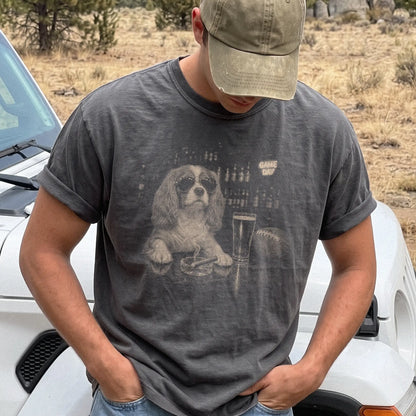 Model wearing a Pepper Comfort Colors® T-shirt featuring Cavalier King Charles Spaniel with beer and football graphics