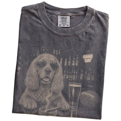 Folded Pepper Comfort Colors® T-shirt showing Cocker Spaniel with beer and football graphics