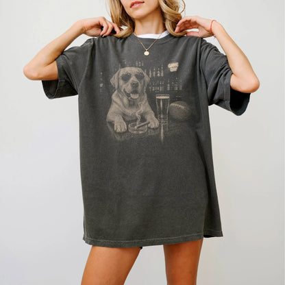 Model wearing a Pepper Comfort Colors® T-shirt featuring Labrador Retriever with beer and football graphics