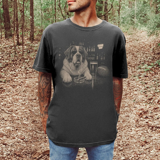 Model wearing a Pepper Comfort Colors® T-shirt featuring Saint Bernard with beer and football graphics