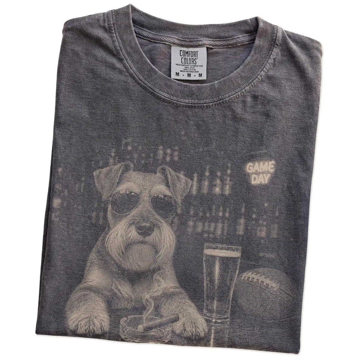 Folded Pepper Comfort Colors® T-shirt showing Schnauzer with beer and football graphics
