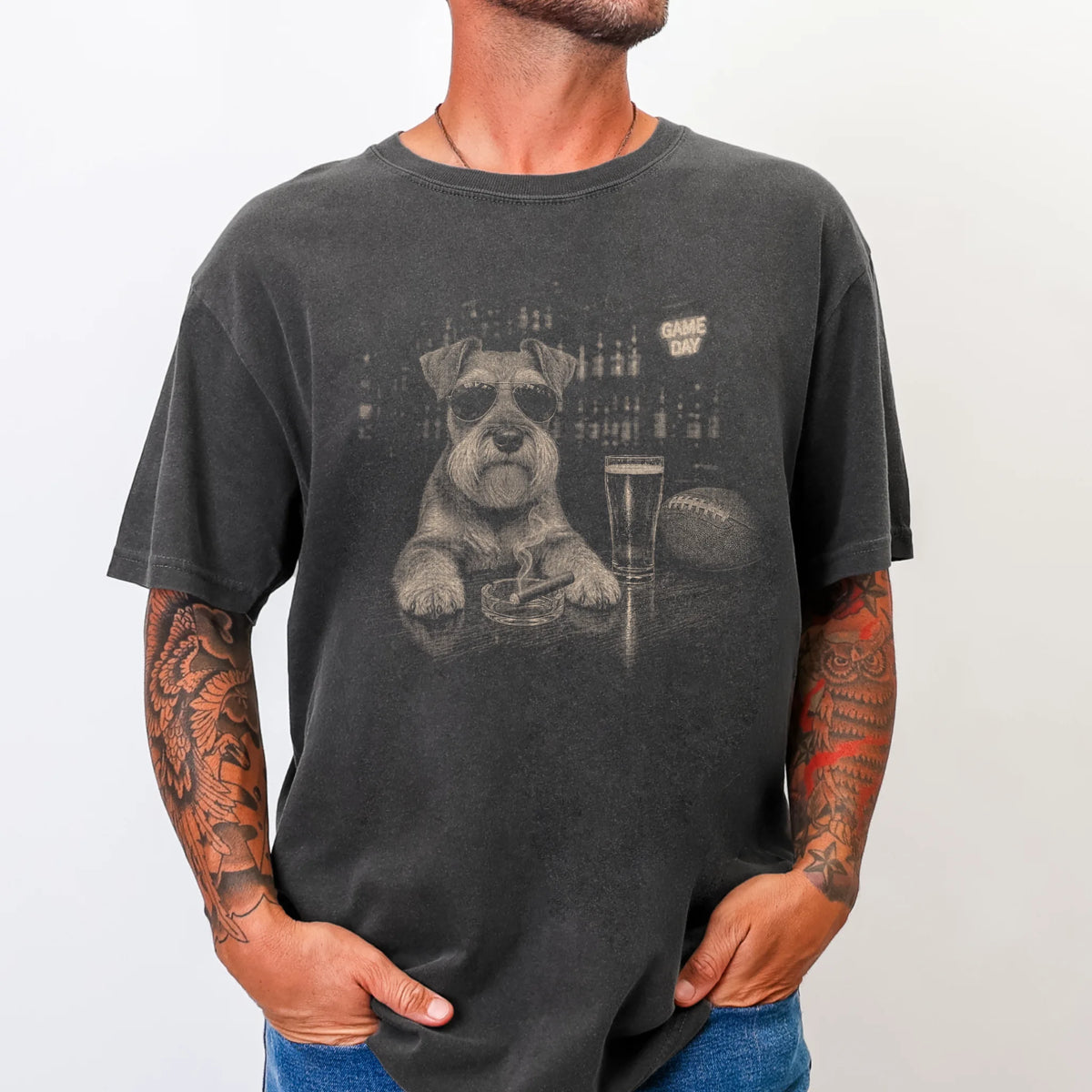 Model wearing a Pepper Comfort Colors® T-shirt featuring Schnauzer with beer and football graphics