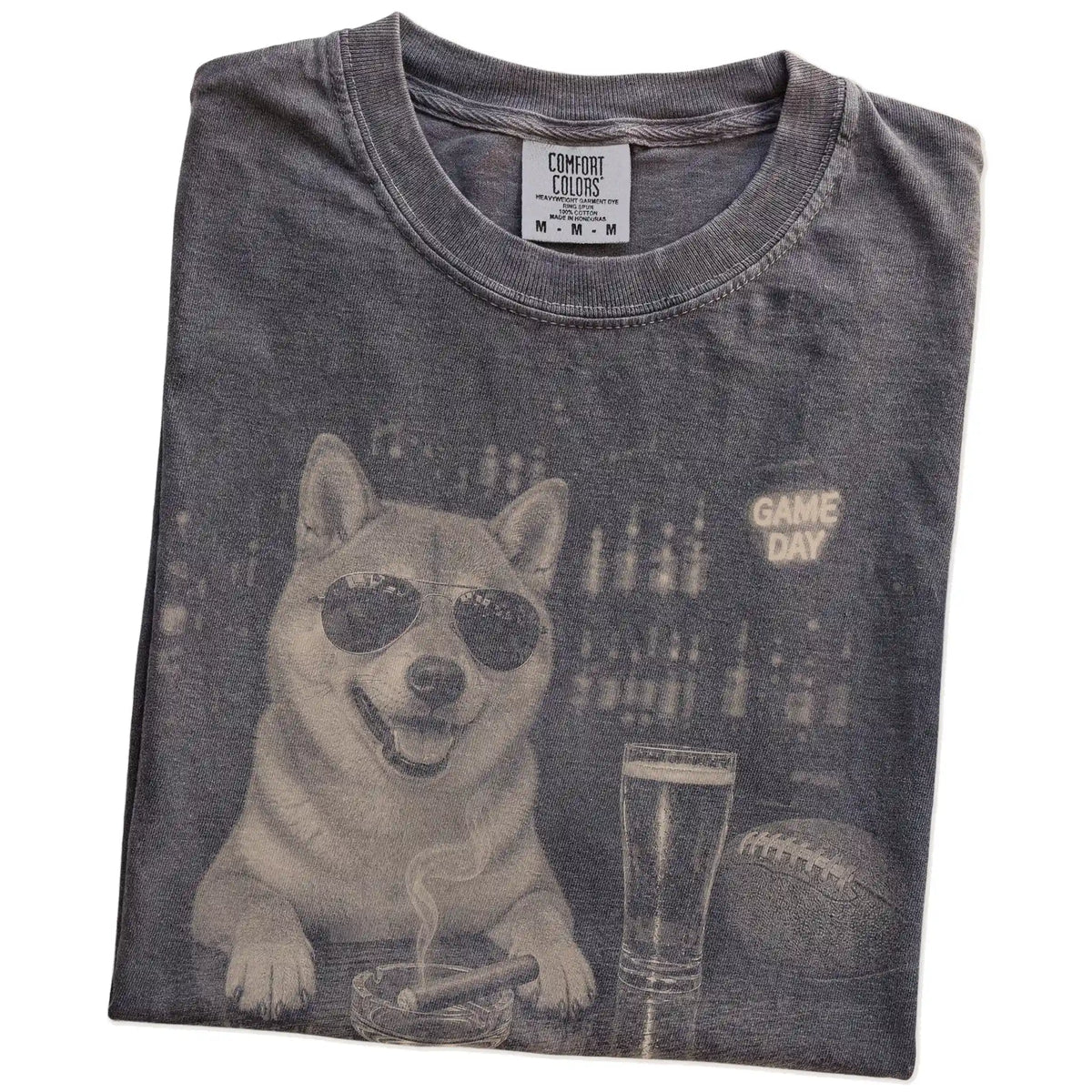 Folded Pepper Comfort Colors® T-shirt showing Shiba Inu with beer and football graphics