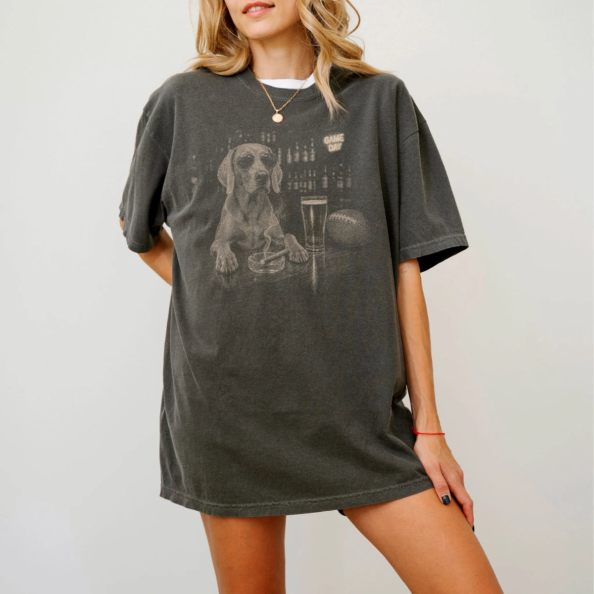 Model wearing a Pepper Comfort Colors® T-shirt featuring Weimaraner with beer and football graphics